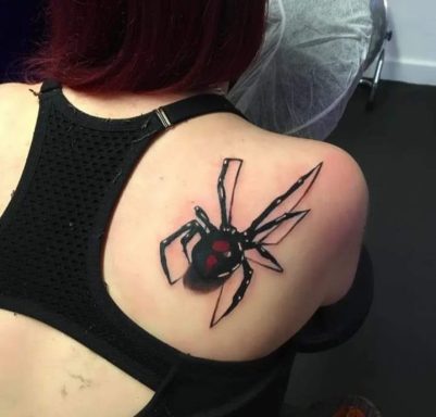A black widow spider tattoo with red accents on a person's upper back.