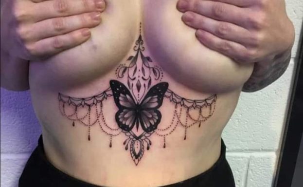 Tattoo design featuring a butterfly and ornate patterns on the torso.