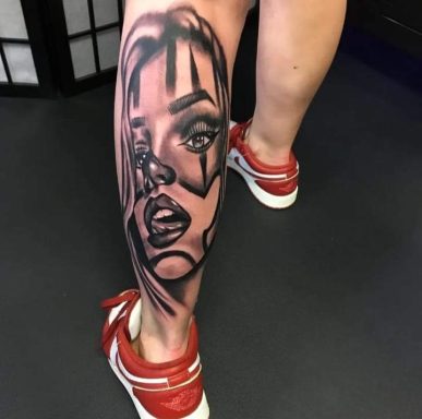A leg tattoo featuring a stylised portrait of a woman in black ink.