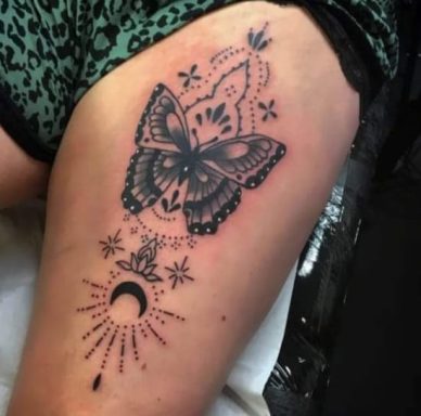 Tattoo design featuring a butterfly with floral elements and a crescent moon.