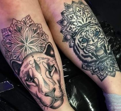 Two detailed animal tattoos: a lioness on the left and a tiger on the right, both with mandala designs.
